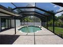 An enclosed pool area with brick patio, screen enclosure and lovely accents at 15037 Mcgraw Ave, Port Charlotte, FL 33953