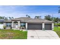 Attractive single-Gathering home with a lush green lawn and a spacious three-car garage at 1546 Gourmet Rd, North Port, FL 34288