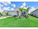 Charming single-story home with a well-maintained front lawn and lush landscaping at 16336 Preservation Blvd, Punta Gorda, FL 33982