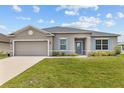 Charming one-story home with blue shutters, manicured lawn, and inviting curb appeal at 17200 Gulfspray Cir, Port Charlotte, FL 33948