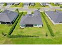 Birds-eye view of a private backyard, green lawn, and manicured hedges surrounding the property at 17336 Sandpearl Rd, Venice, FL 34293