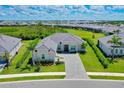 Expansive aerial view of a home with lush green landscaping in a serene residential community at 17336 Sandpearl Rd, Venice, FL 34293