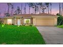 Well-maintained single-story home with manicured lawn and cozy front yard at dusk at 1983 Longstroth Ave, North Port, FL 34288