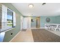 Bright entryway with tile flooring, a built-in bench, and natural light at 21524 Edgewater Dr, Port Charlotte, FL 33952