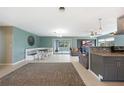 Open concept living room with tile flooring, dining area, and seamless flow to kitchen at 21524 Edgewater Dr, Port Charlotte, FL 33952
