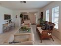 Living room with tiled floors and bright windows with shutters provides ample light at 2220 Broad Ranch Dr, Port Charlotte, FL 33948