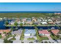 An aerial view showcases the property within its waterfront community and meticulous landscaping at 245 Lido Dr, Punta Gorda, FL 33950