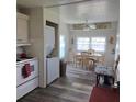 View of the kitchen leading into a dining area with a charming round table at 326 Trailorama Dr, North Port, FL 34287