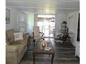 Cozy living room with a sliding glass door to a screened patio at 326 Trailorama Dr, North Port, FL 34287