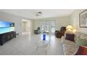 Inviting living room with neutral tones, tile flooring, and comfortable seating at 475 Whippoorwill Dr, Venice, FL 34293