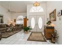 Elegant foyer with high ceilings, tile flooring, and a decorative chandelier at 5048 San Massimo Dr, Punta Gorda, FL 33950