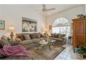 Comfortable living room featuring large windows, plush seating, and a ceiling fan at 5048 San Massimo Dr, Punta Gorda, FL 33950