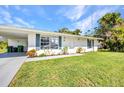Single-story home featuring a well-maintained lawn and walkway with green landscaping at 769 Crestview Nw Cir, Port Charlotte, FL 33948
