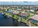 A fantastic aerial view of the canal-front property highlighting the outdoor pool, patio, and screened-in area at 825 Via Tunis, Punta Gorda, FL 33950