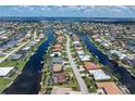 Beautiful aerial shot showcasing the property's waterfront location and its surroundings in a canal-filled community at 825 Via Tunis, Punta Gorda, FL 33950