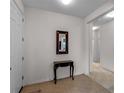 Bright foyer featuring tile flooring and a decorative table with mirror at 8814 Tuscany Isles Dr, Punta Gorda, FL 33950