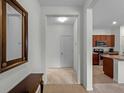 Light-filled foyer with beige carpet leading into the kitchen at 8814 Tuscany Isles Dr, Punta Gorda, FL 33950