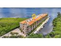 Stunning waterfront condo building showcasing boat docks and architectural details against a serene bay backdrop at 900 E Marion Ave # 1403, Punta Gorda, FL 33950