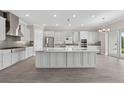 Spacious kitchen featuring a large island, stainless steel appliances, and modern finishes at 14846 Contenta Loop, Bradenton, FL 34211