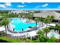 Expansive community pool area with lounge chairs and lush tropical landscaping at 14846 Contenta Loop, Bradenton, FL 34211