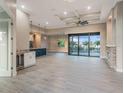 Spacious living room featuring tile floors, a ceiling fan, and large glass sliding doors at 4026 Vasco St, Punta Gorda, FL 33950