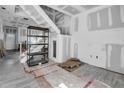 Living room under renovation features stairs and new floors ready for finishing touches at 7696 Plantation Cir, Bradenton, FL 34201