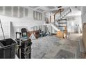 Spacious living room undergoing renovations, featuring stairs, and ample natural light at 7696 Plantation Cir, Bradenton, FL 34201