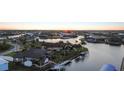 Expansive waterfront property with private dock and boat lift at sunset at 8178 Arlewood Cir, Port Charlotte, FL 33981