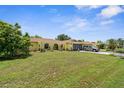 Charming yellow home with a well-manicured lawn and a two-car garage at 2381 Montpelier Rd, Punta Gorda, FL 33983