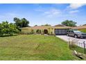 Charming yellow home with a well-manicured lawn and a two-car garage at 2381 Montpelier Rd, Punta Gorda, FL 33983