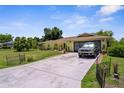 Charming yellow home with a well-manicured lawn and a two-car garage at 2381 Montpelier Rd, Punta Gorda, FL 33983