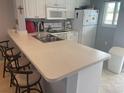 Open-concept kitchen with bar-stool seating and ample counter space at 25275 Rampart Blvd # 207, Punta Gorda, FL 33983
