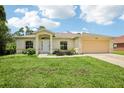 Beautiful single-story home with a well-kept lawn, attached two car garage, and inviting front doorway at 5260 Jessamine Ave, North Port, FL 34291