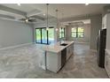 Modern kitchen with white cabinets, island, and stainless steel appliances at 24167 Santa Inez Rd, Punta Gorda, FL 33955