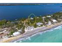 Panoramic aerial view showcasing the home's waterfront location with a beach, and a private dock at 6895 Manasota Key Rd, Englewood, FL 34223