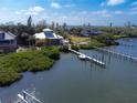 Expansive aerial view featuring a waterfront estate with a dock, lush greenery, and breathtaking water views at 6895 Manasota Key Rd, Englewood, FL 34223