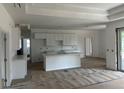 Bright, open kitchen with white cabinets, quartz countertops and large island, still under construction at 5462 Gagnon Ter, North Port, FL 34291