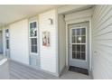 Condo entry with light gray door and white siding at 7446 Palm Island Dr # 3514, Placida, FL 33946