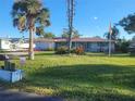 Ranch-style home with a well-maintained lawn at 745 Coral Way, Englewood, FL 34223