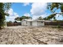 View of the backyard, showing a mostly cleared sandy area at 1670 Lakeview Pl, Englewood, FL 34223