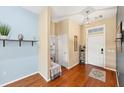 Bright and airy entryway with wood floors, built-in bench, and access to laundry at 7192 N Paragon Rd, North Port, FL 34291