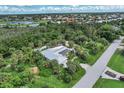 Single-story home with solar panels and tropical landscaping at 120 Barracuda Dr, Placida, FL 33946