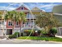 Two-story townhome with inviting front porch and lush landscaping at 11708 Anglers Club Dr # 125, Placida, FL 33946