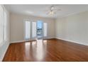 Main bedroom with hardwood floors and access to balcony and water views at 11708 Anglers Club Dr # 125, Placida, FL 33946