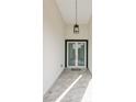 Bright entryway with double glass doors and pendant light at 118 Green Pine Park, Rotonda West, FL 33947