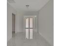 Modern entryway with marble floors and double doors at 118 Green Pine Park, Rotonda West, FL 33947