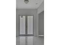 Clean entryway with marble floors and double doors at 118 Green Pine Park, Rotonda West, FL 33947