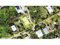Aerial view of a single-Gathering home on a tree-lined street, close to the beach at 8934 Gulf St, Placida, FL 33946