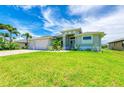 Newly built home with a two-car garage, manicured lawn at 779 Boundary Blvd, Rotonda West, FL 33947