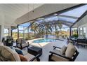 Relaxing screened pool and patio area with comfortable seating at 15390 Ancel Cir, Port Charlotte, FL 33981